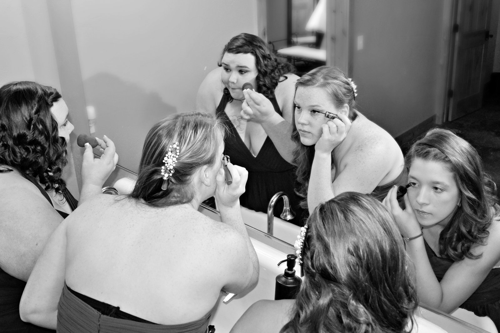 Bridal party doing makeup at the mirror